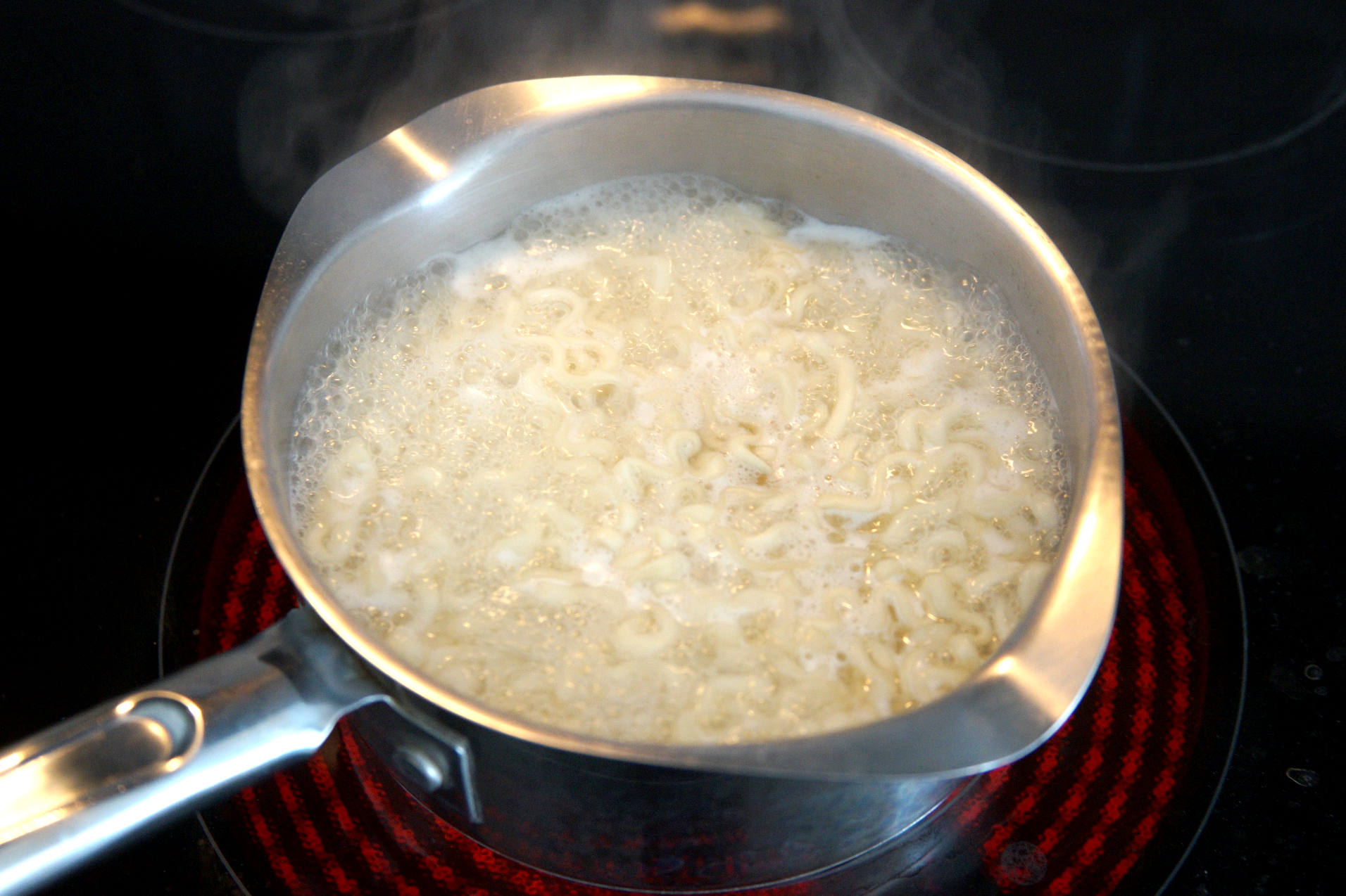 Buldak fire noodles cooking on the stove top